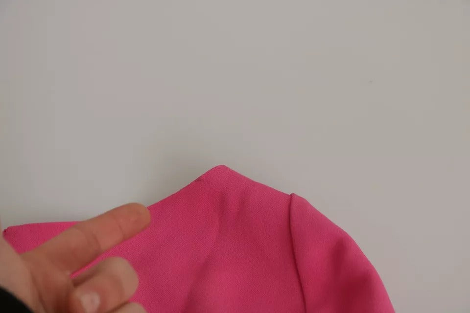 A pink bodycon dress with plunging neckline and sheath style