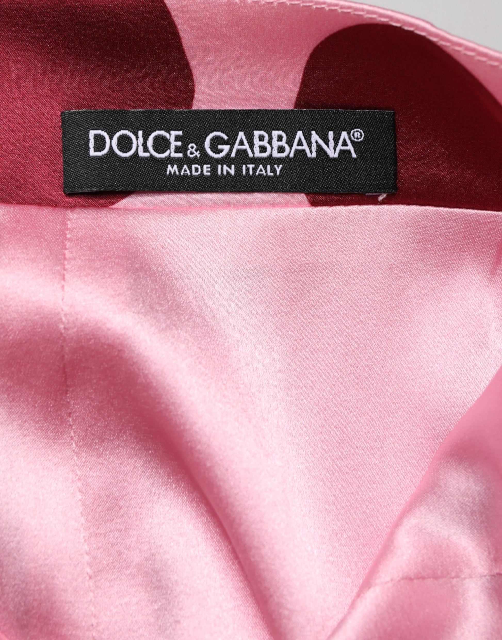 Pink satin fabric with a label that reads "Dolce & Gabbana Made in Italy"