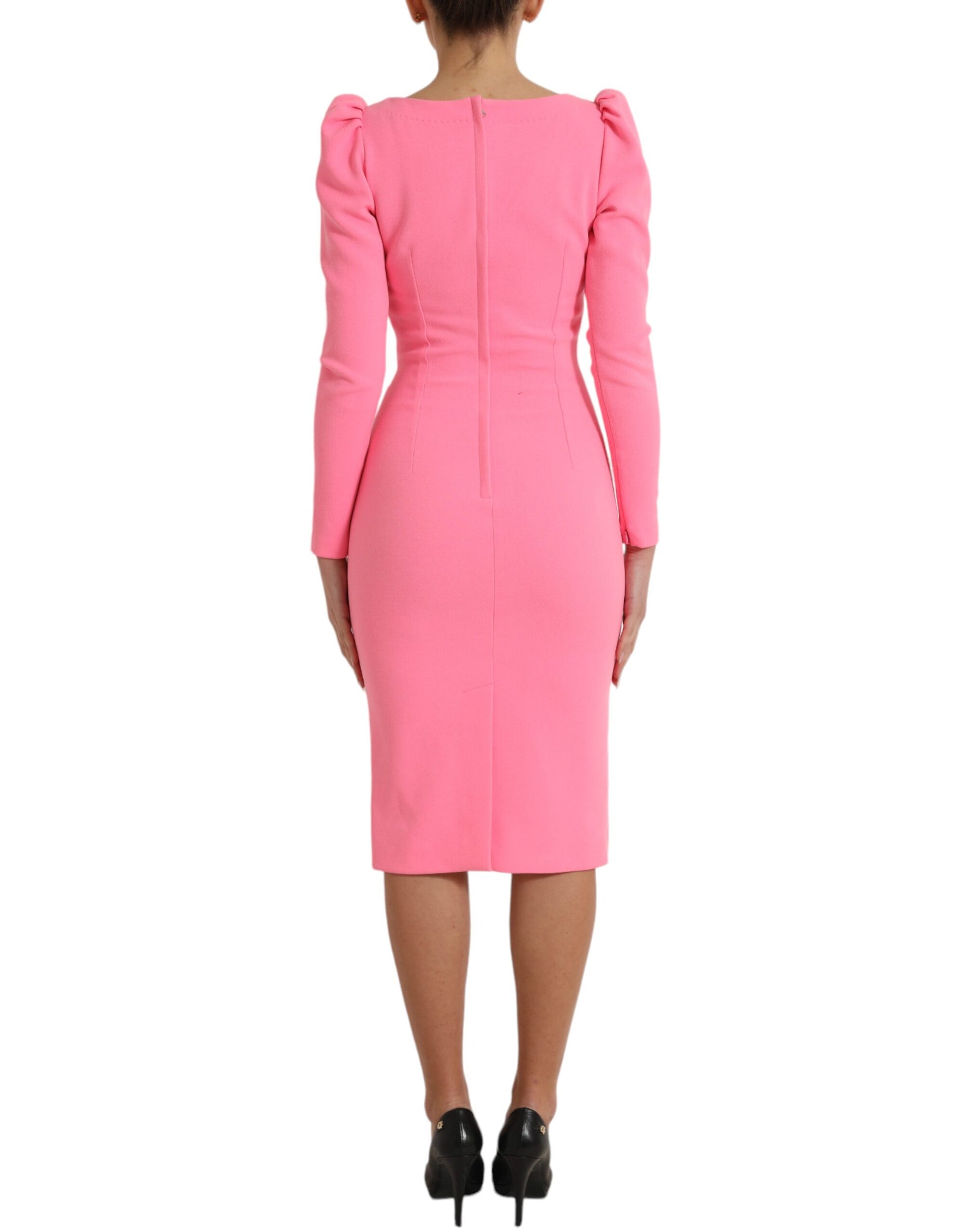 A pink midi dress with long sleeves and a sheath silhouette