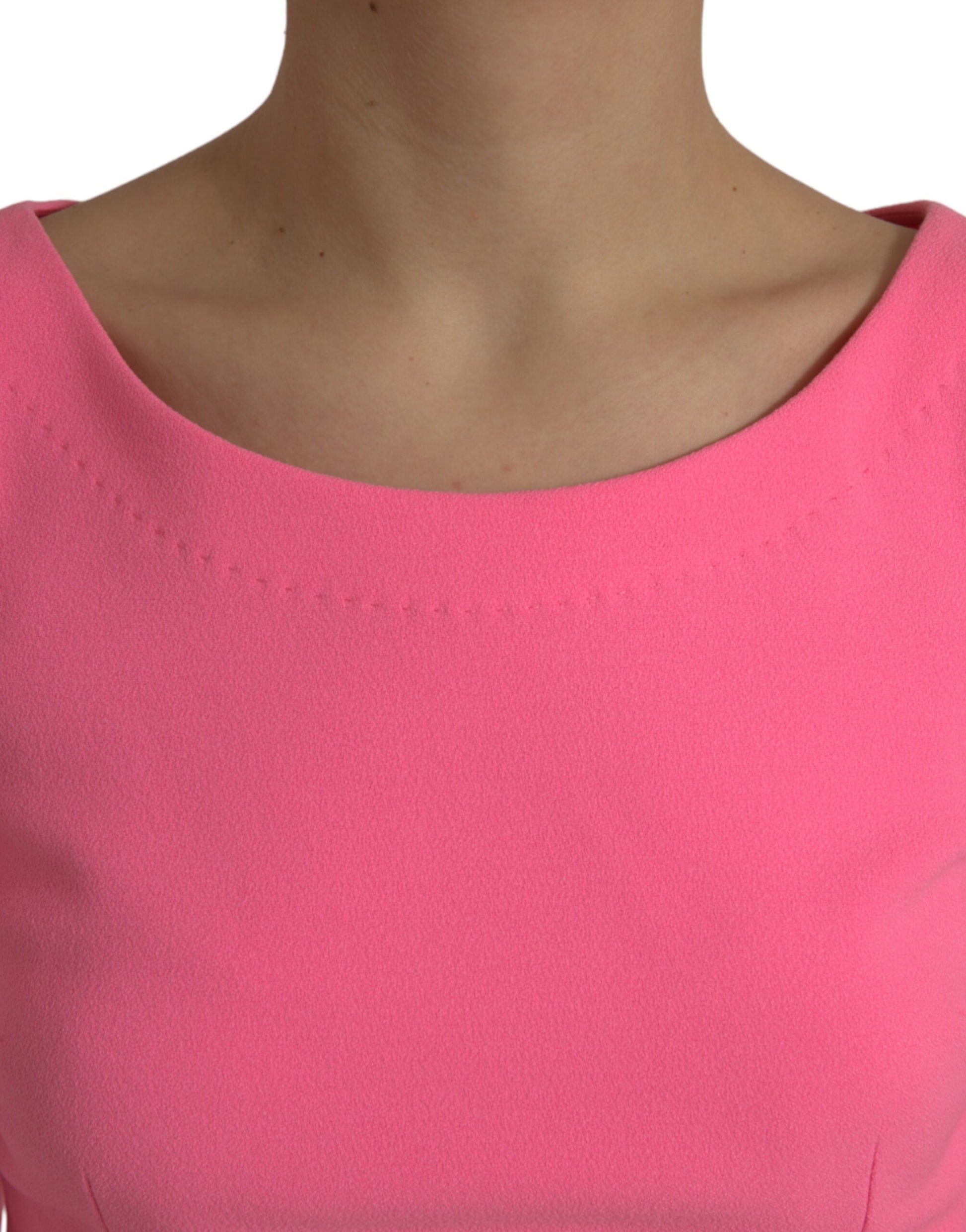 A pink polyester midi dress with long sleeves and a sheath silhouette
