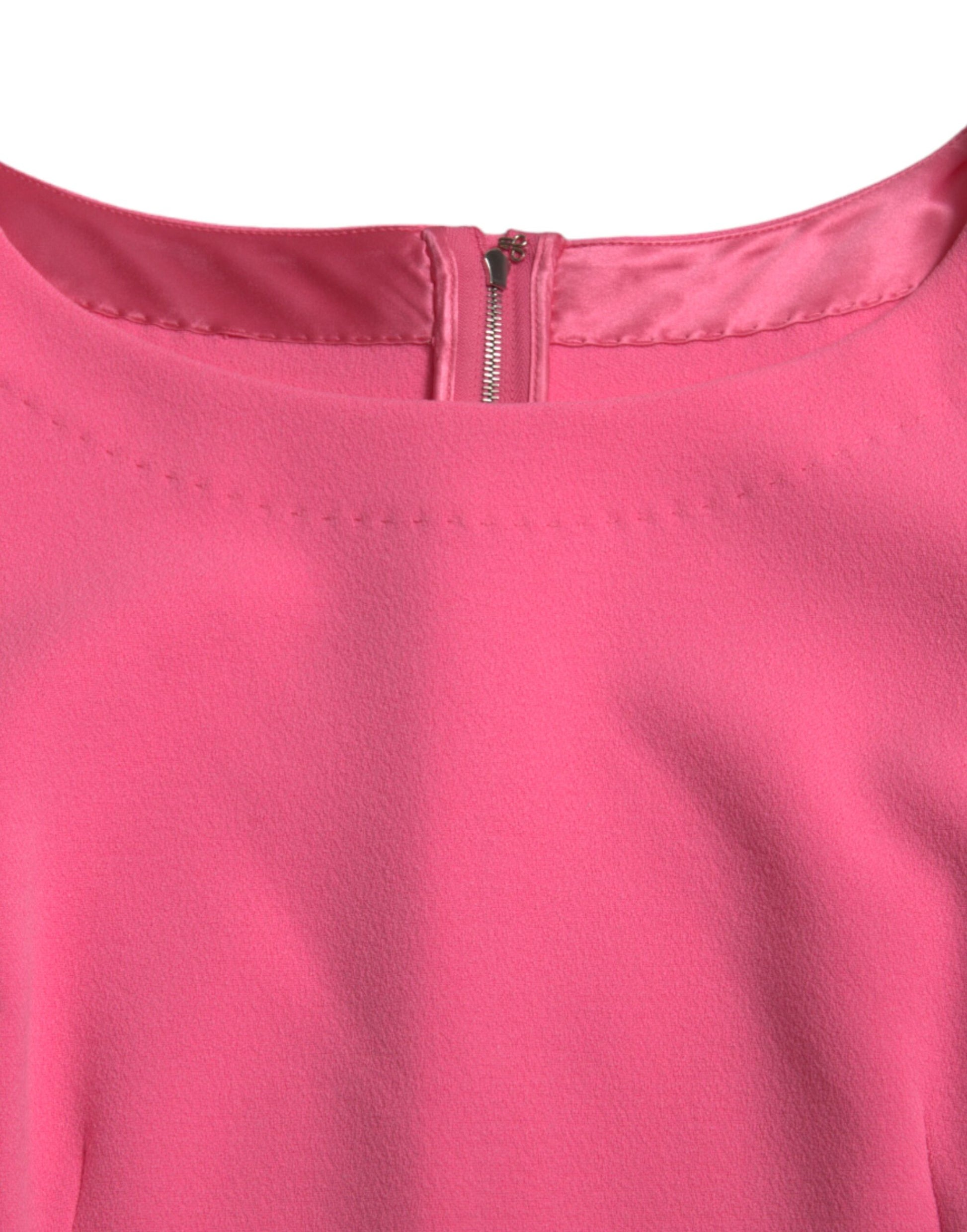 A pink midi dress with long sleeves and a zippered front