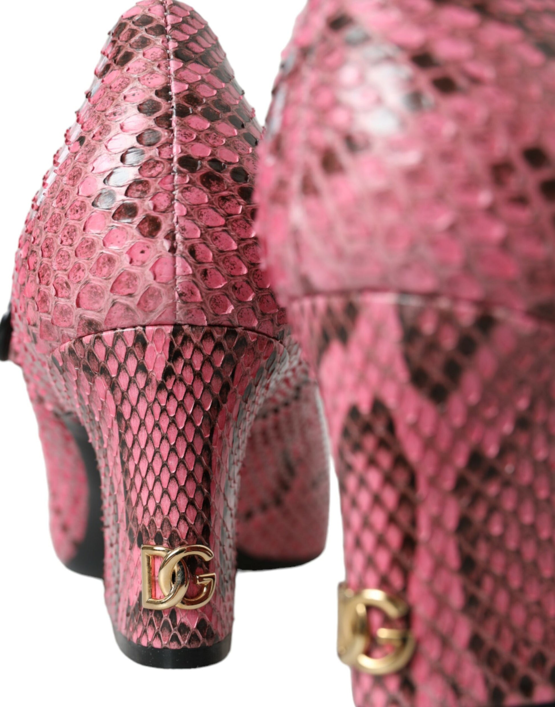 Pair of high heel shoes with pink snakeskin texture and gold hardware