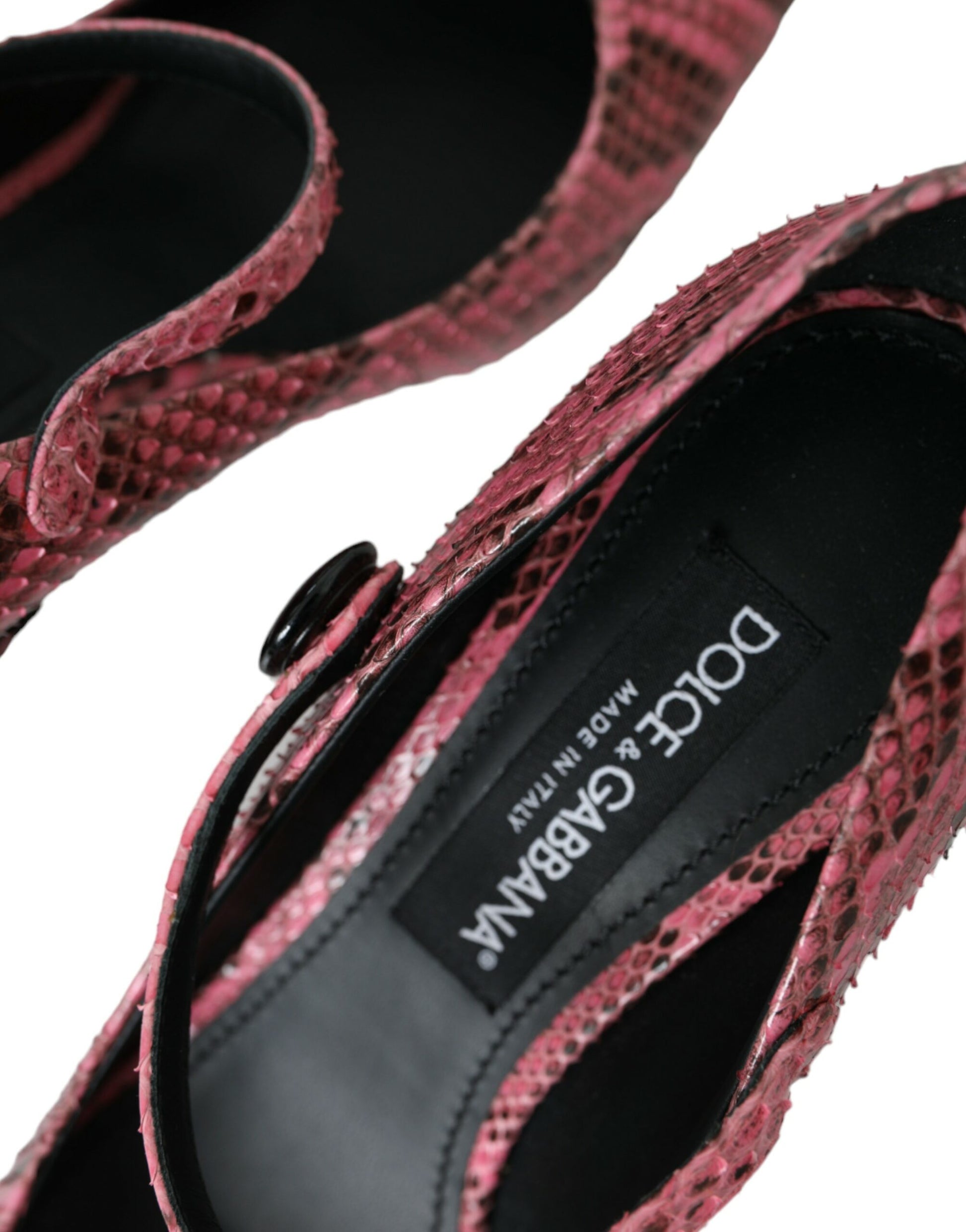 Pair of red sandals with black straps and a patterned sole