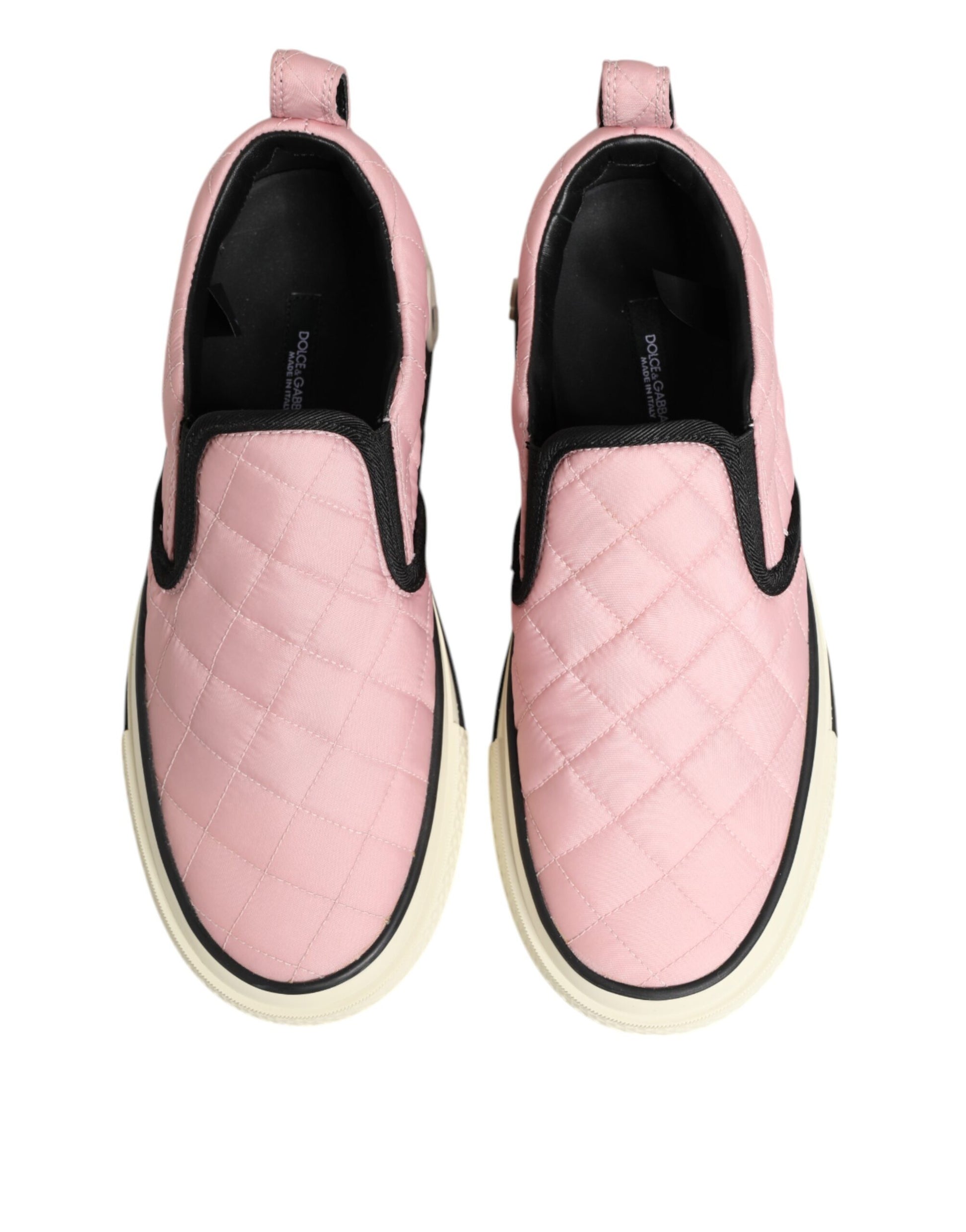 Pair of pink quilted nylon slip-on shoes with black laces and soles