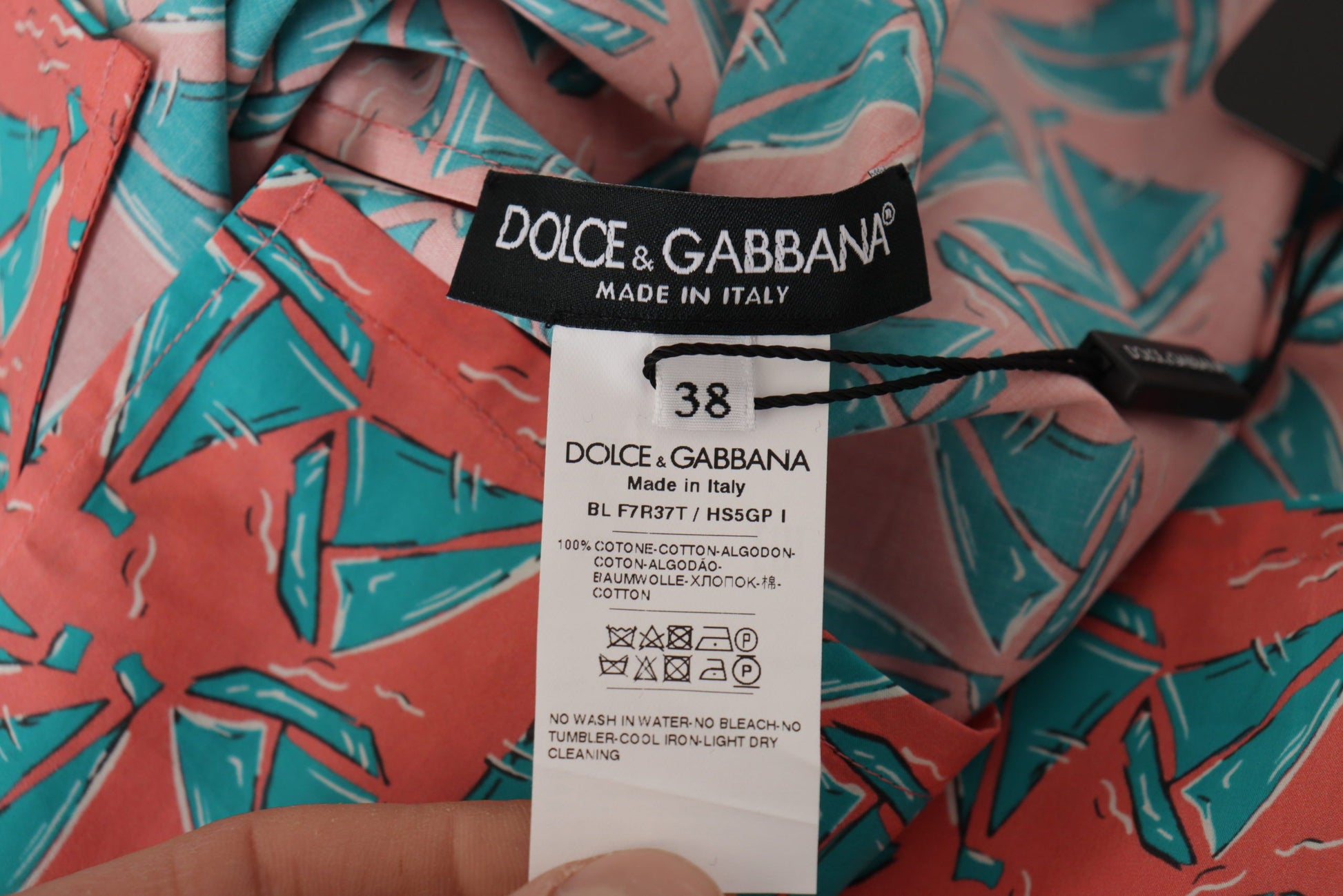 Pink shirt with green pattern on it