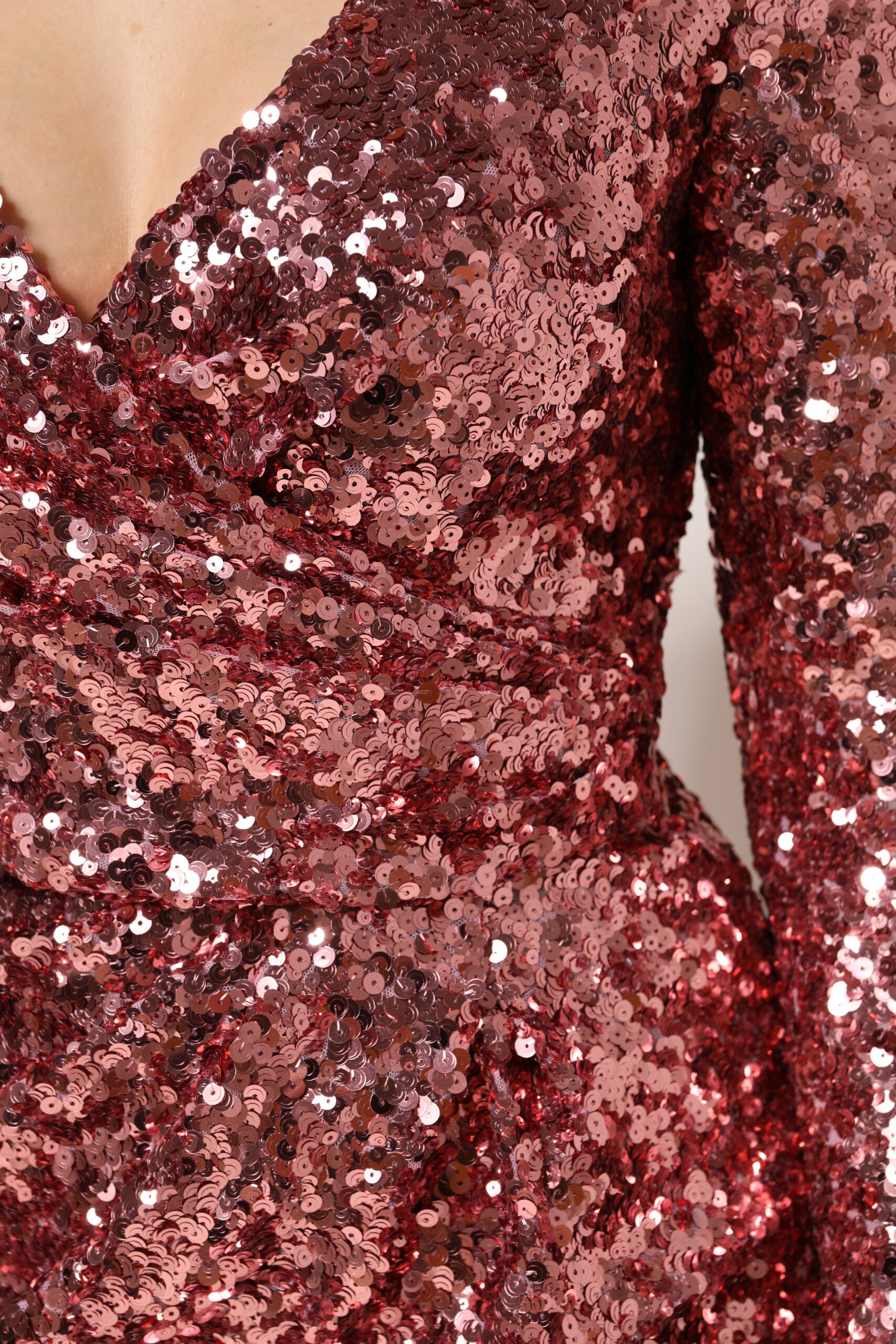 A pink sequin dress with a V-neck and midi length