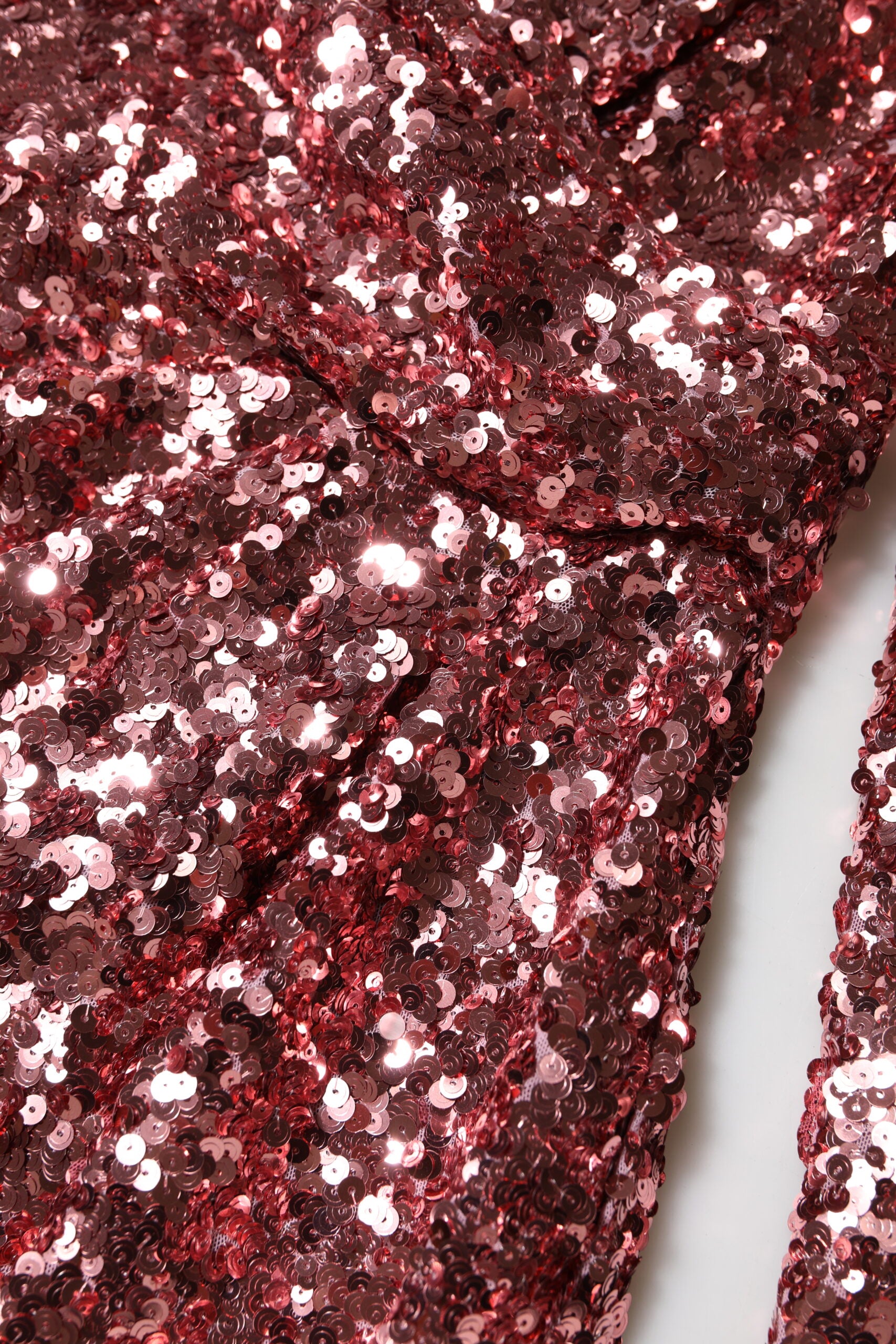 A pink sequin dress with a V-neck and midi length