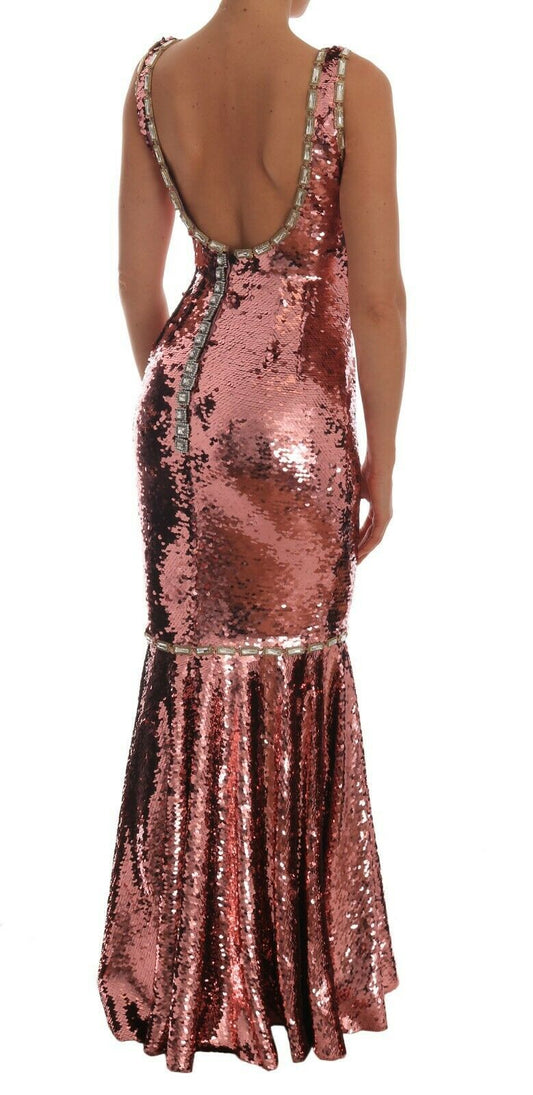 A pink sequined sheath dress with crystals, featuring a deep V-neck and long train