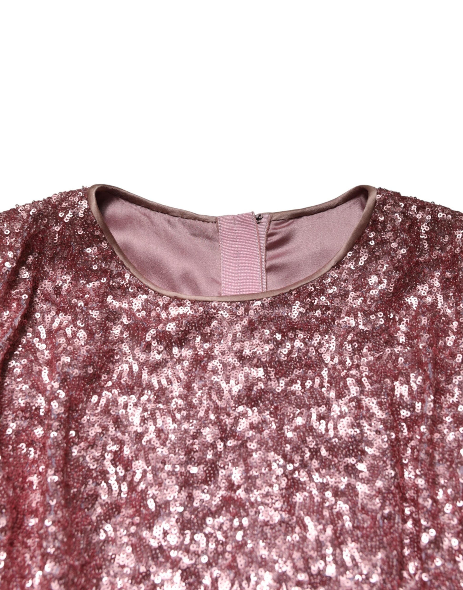 A long pink sequined mermaid dress with a V-neckline