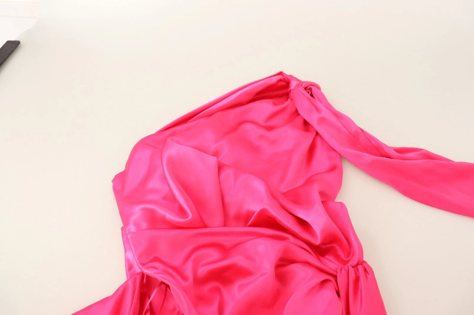 Pink satin dress on table