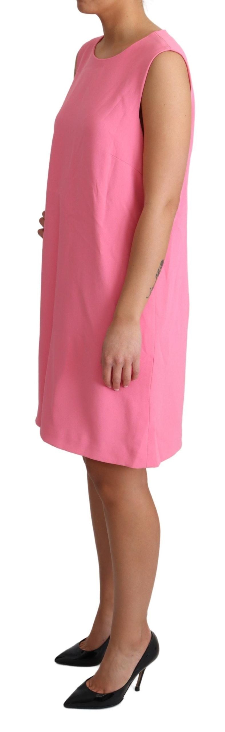 A sleeveless pink dress with a knee length, worn by a mannequin