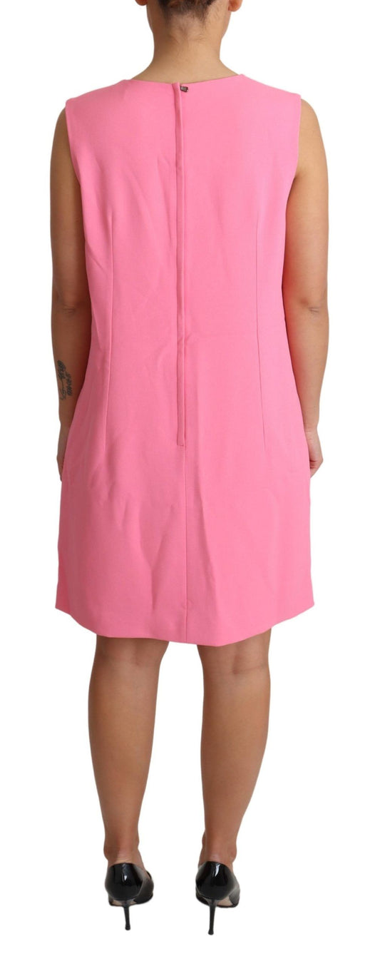 A sleeveless pink dress with a knee length skirt