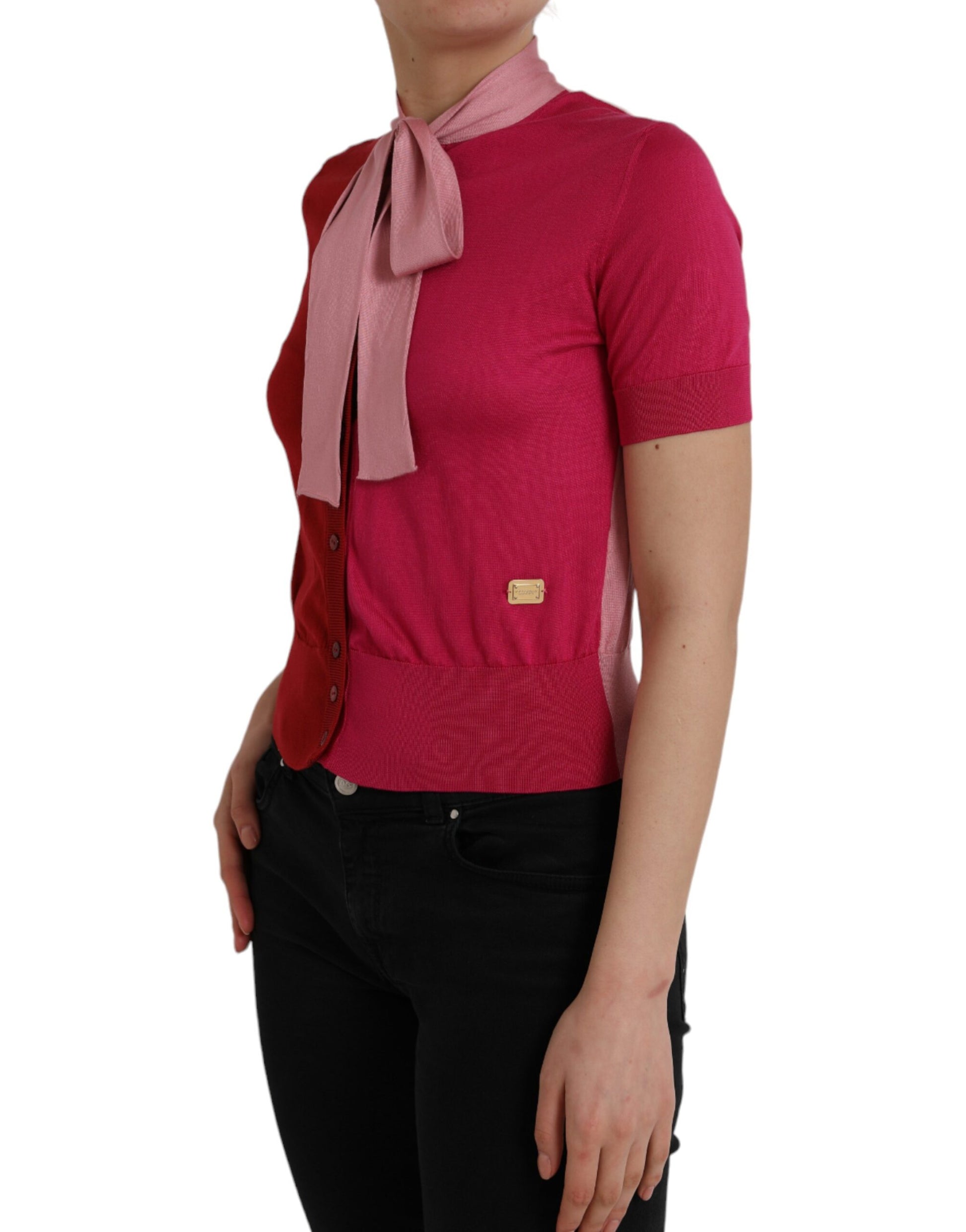 Woman wearing pink sweater with bow tie