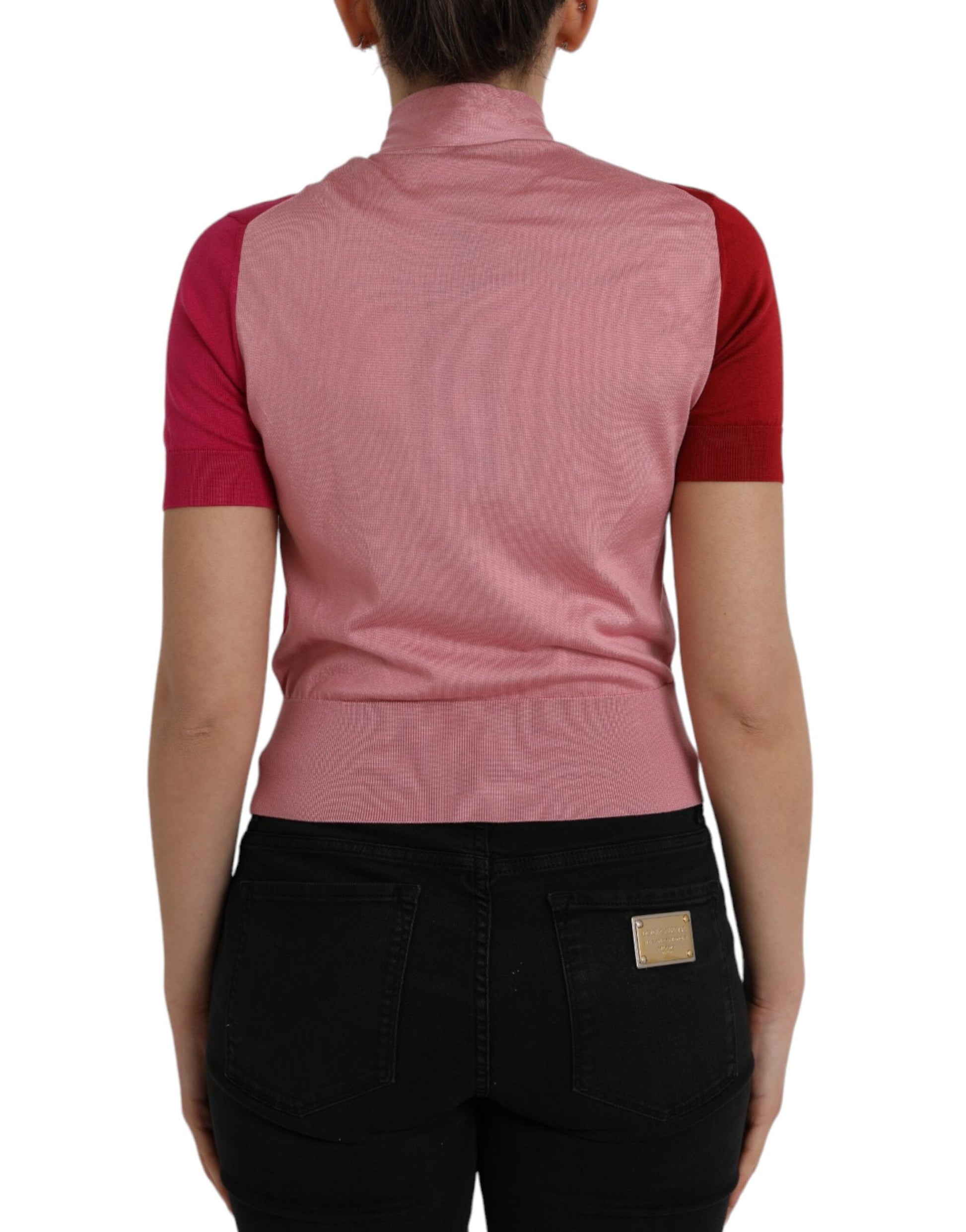 Pink vest over black pants