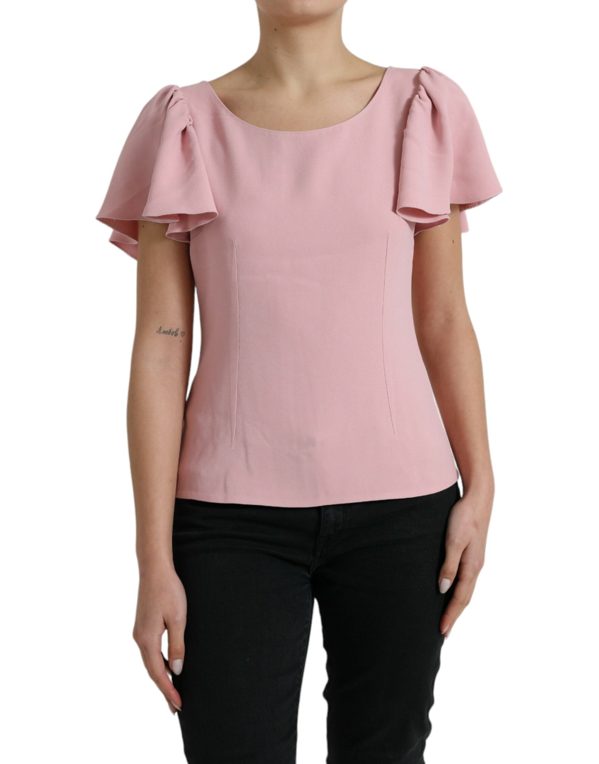 Pink blouse with ruffled sleeves worn by a woman