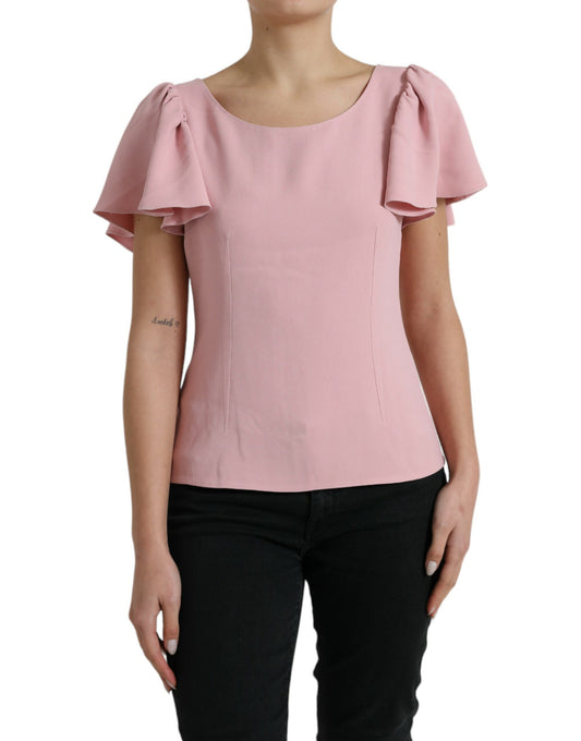Pink blouse with ruffled sleeves worn by a woman
