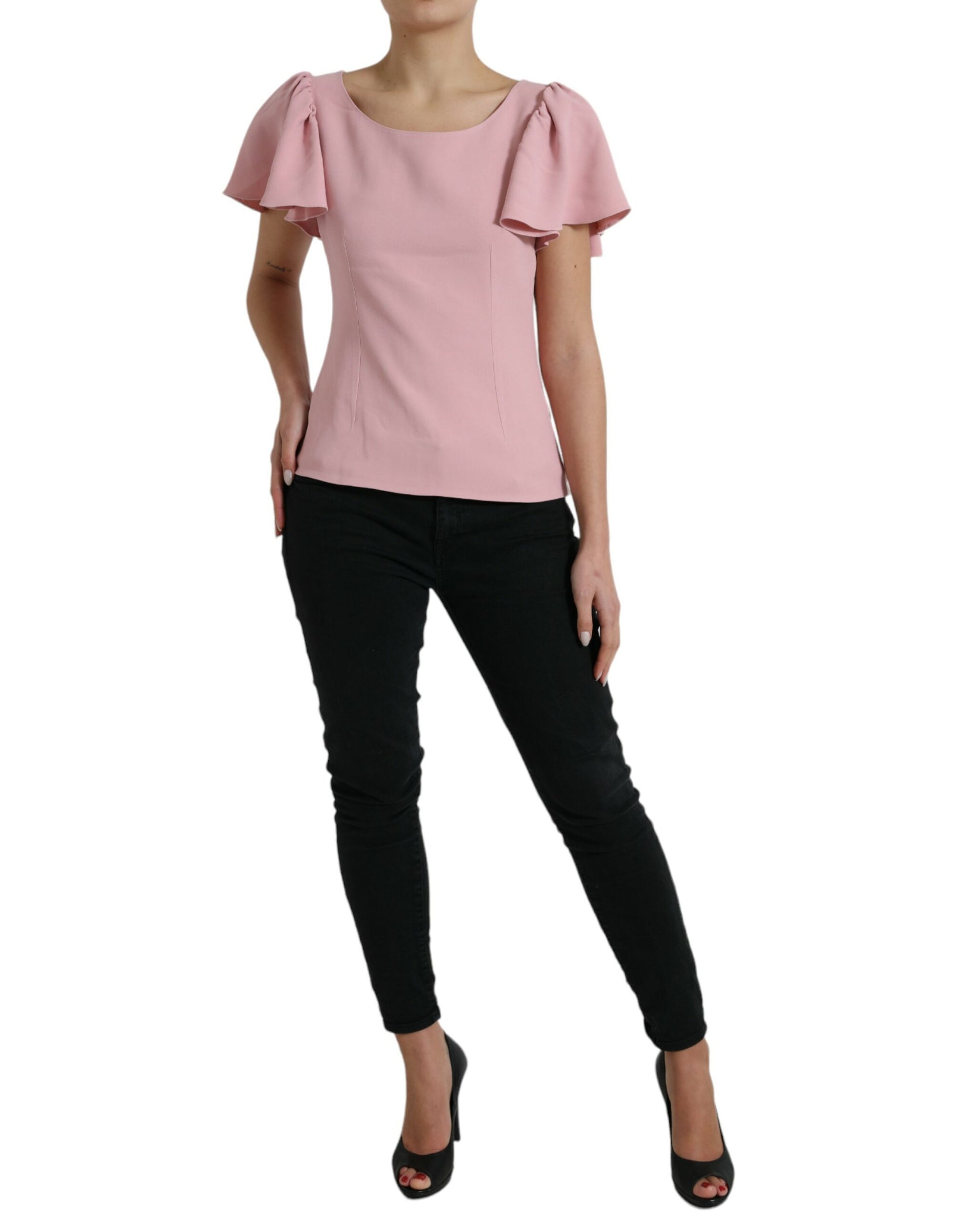 Woman wearing pink blouse and black pants