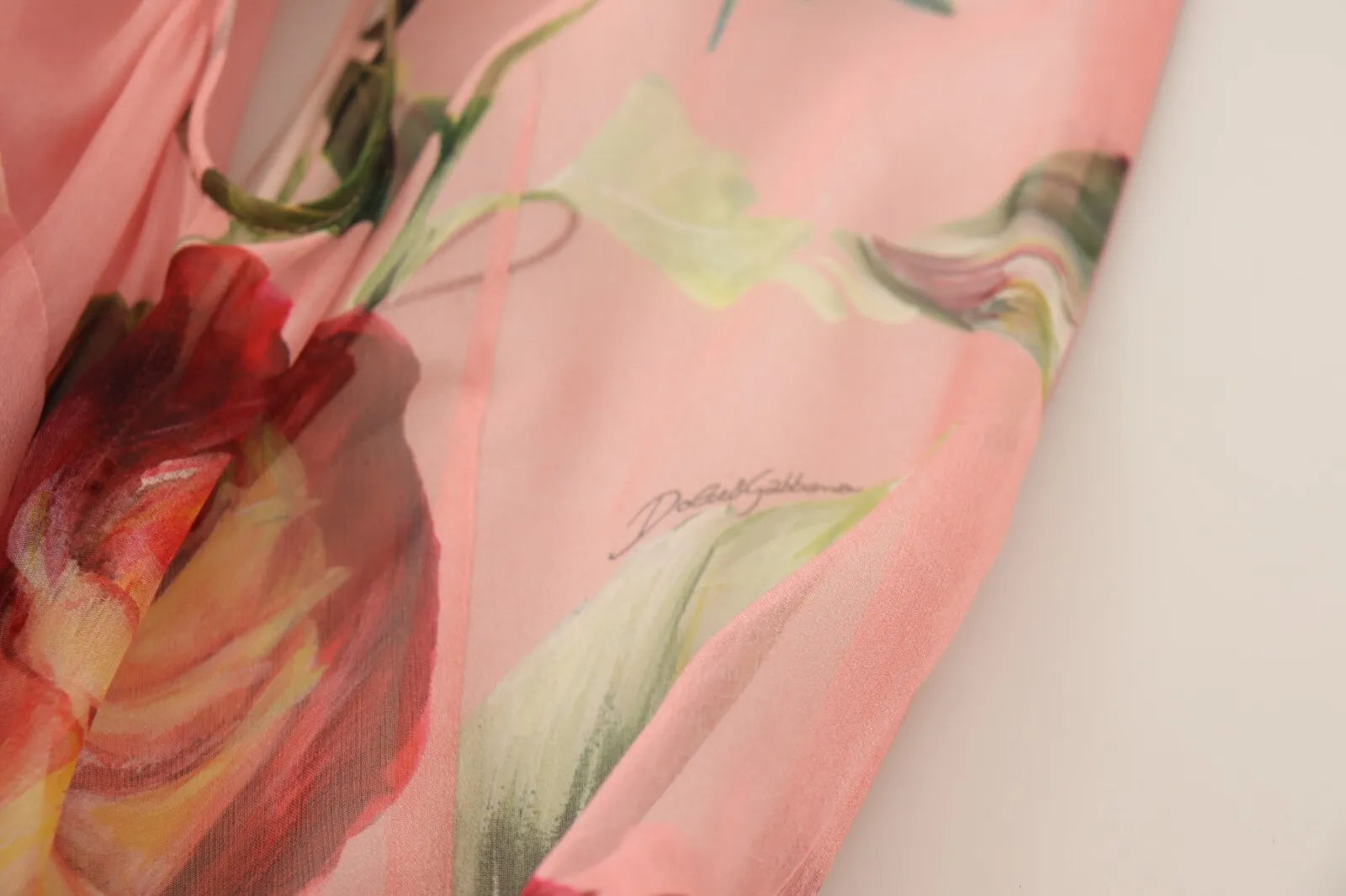A pink floral print maxi dress with layered design and silk fabric