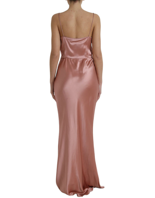 A long pink silk dress with spaghetti straps and a backless design