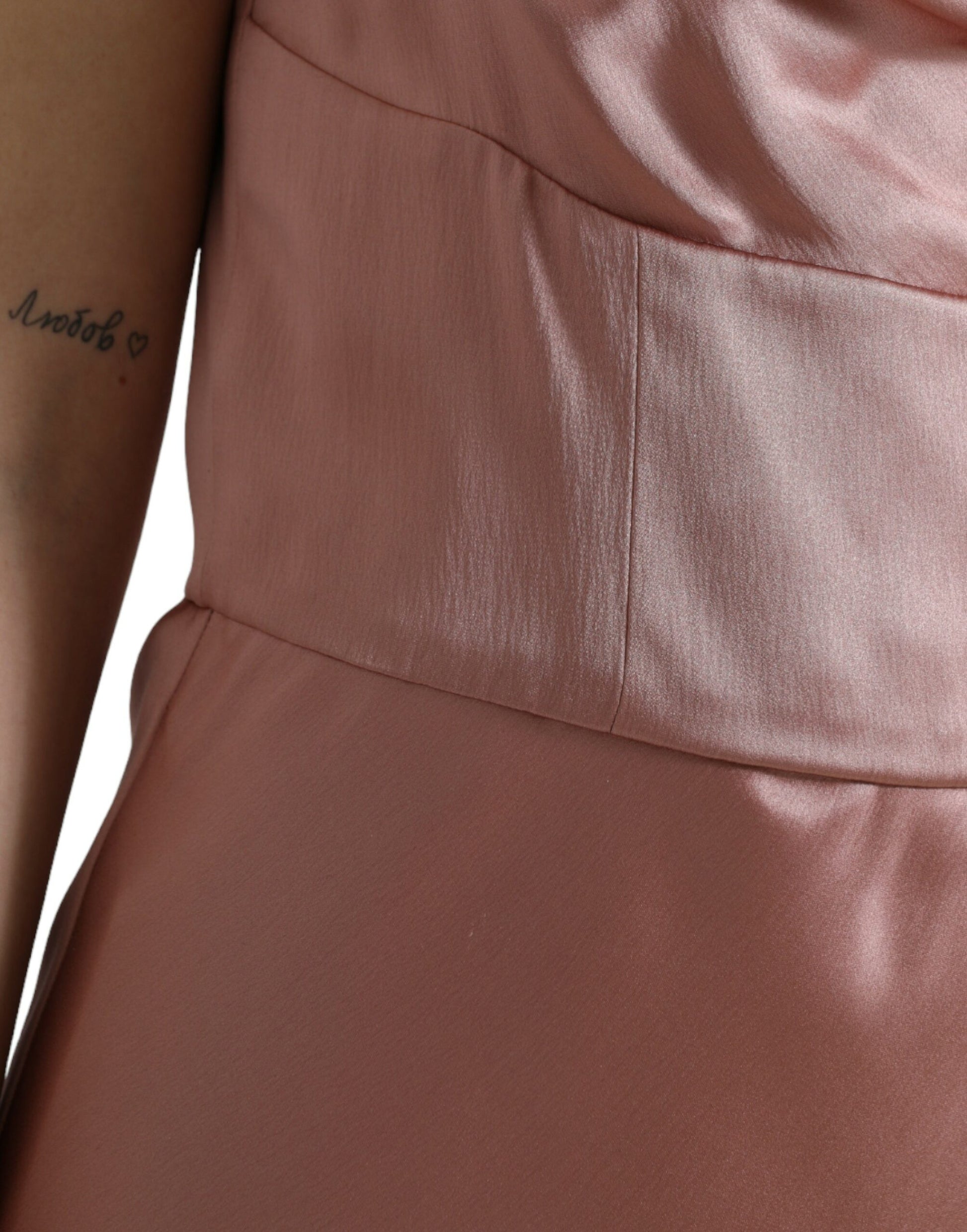 A pink silk spaghetti straps long gown dress with a fitted bodice and flared skirt