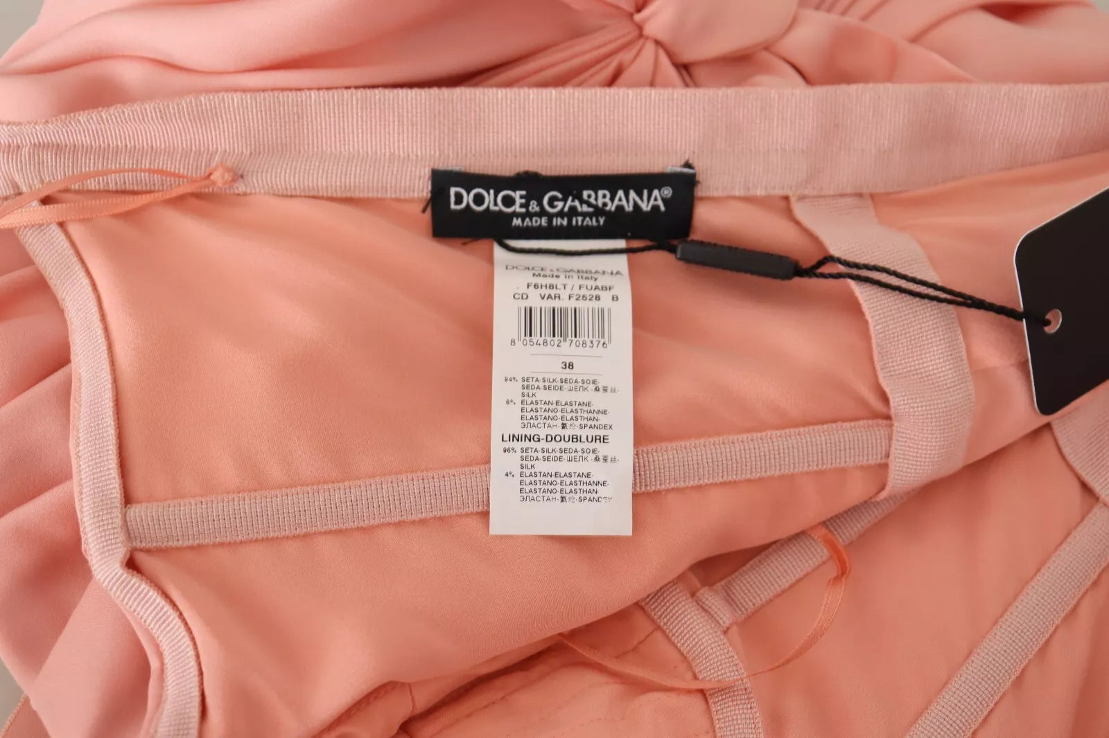 A pink strapless sheath dress with a stretchy fabric, branded by Dolce & Gabbana