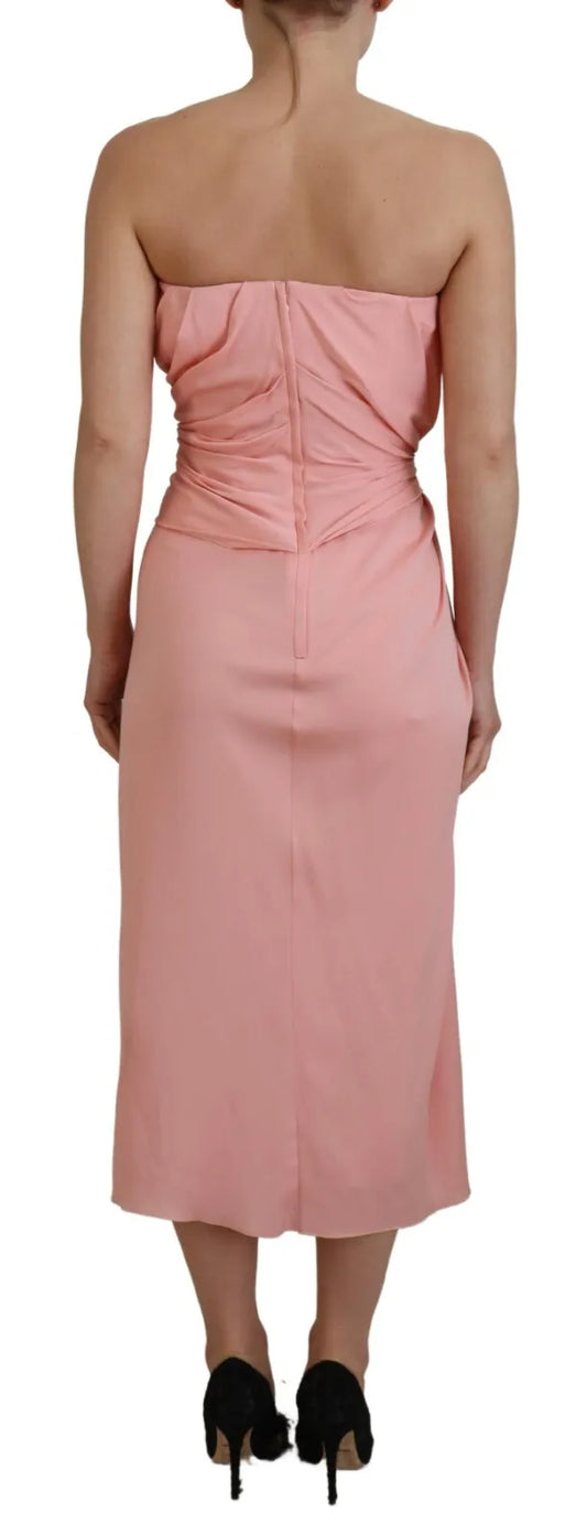 A pink strapless sheath dress with a fitted silhouette and stretchy fabric