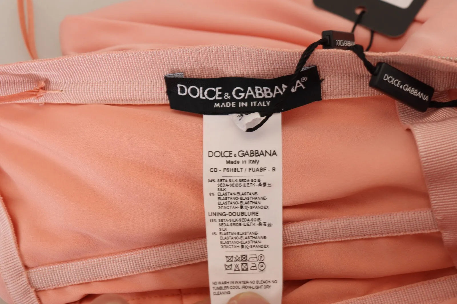 A pink strapless sheath dress with a stretchy silky fabric