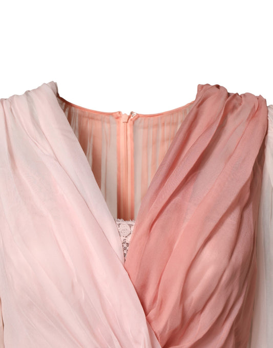 A pink silk tulle dress with long sleeves and a V-neck
