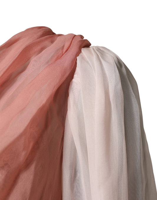 A pink silk tulle dress with long sleeves and a V-neck