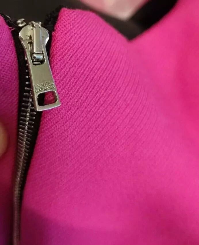 A pink sleeveless bodycon dress with a zipper closure