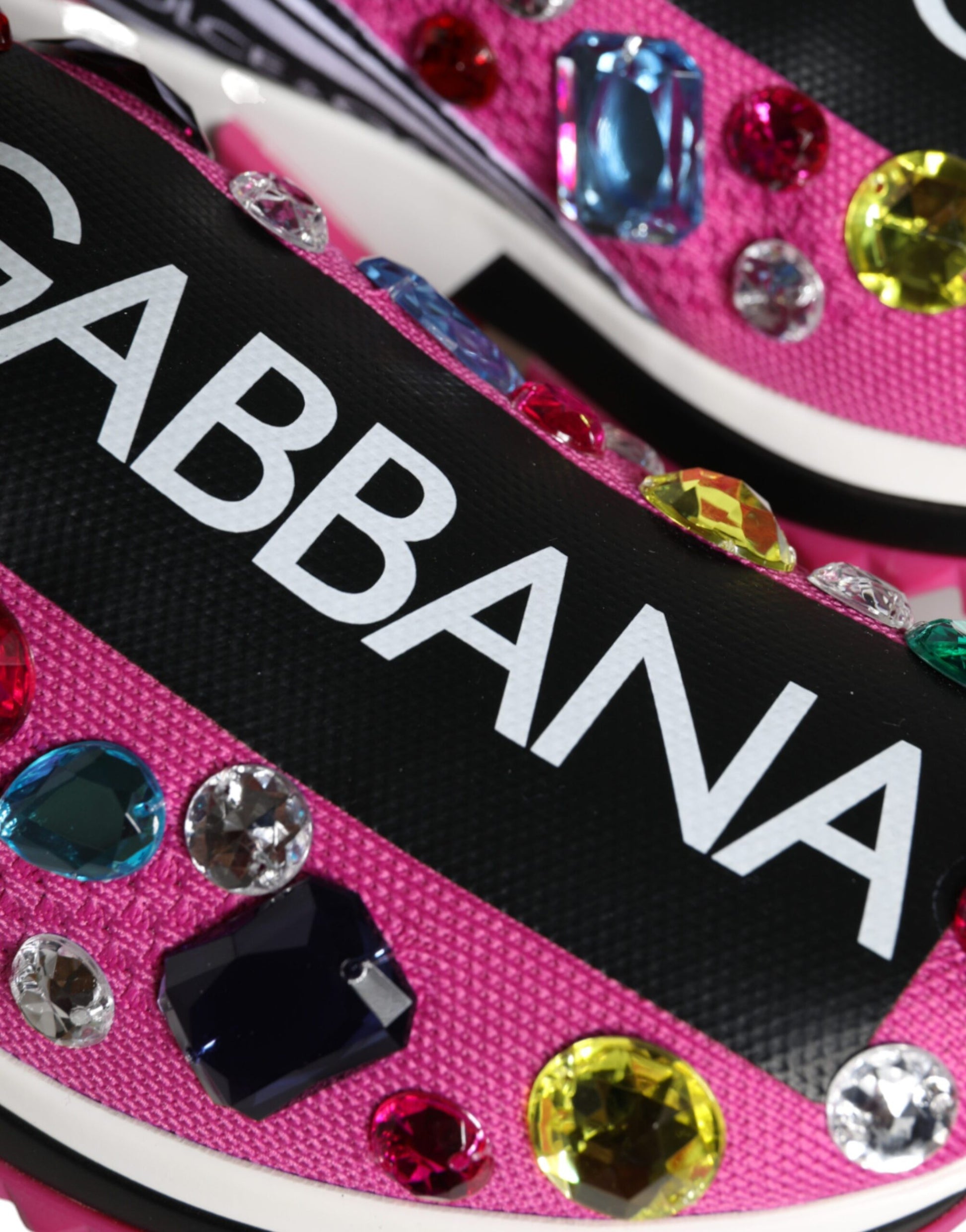 Pair of pink shoes with crystal embellishments and the word "GABBANA" written on them