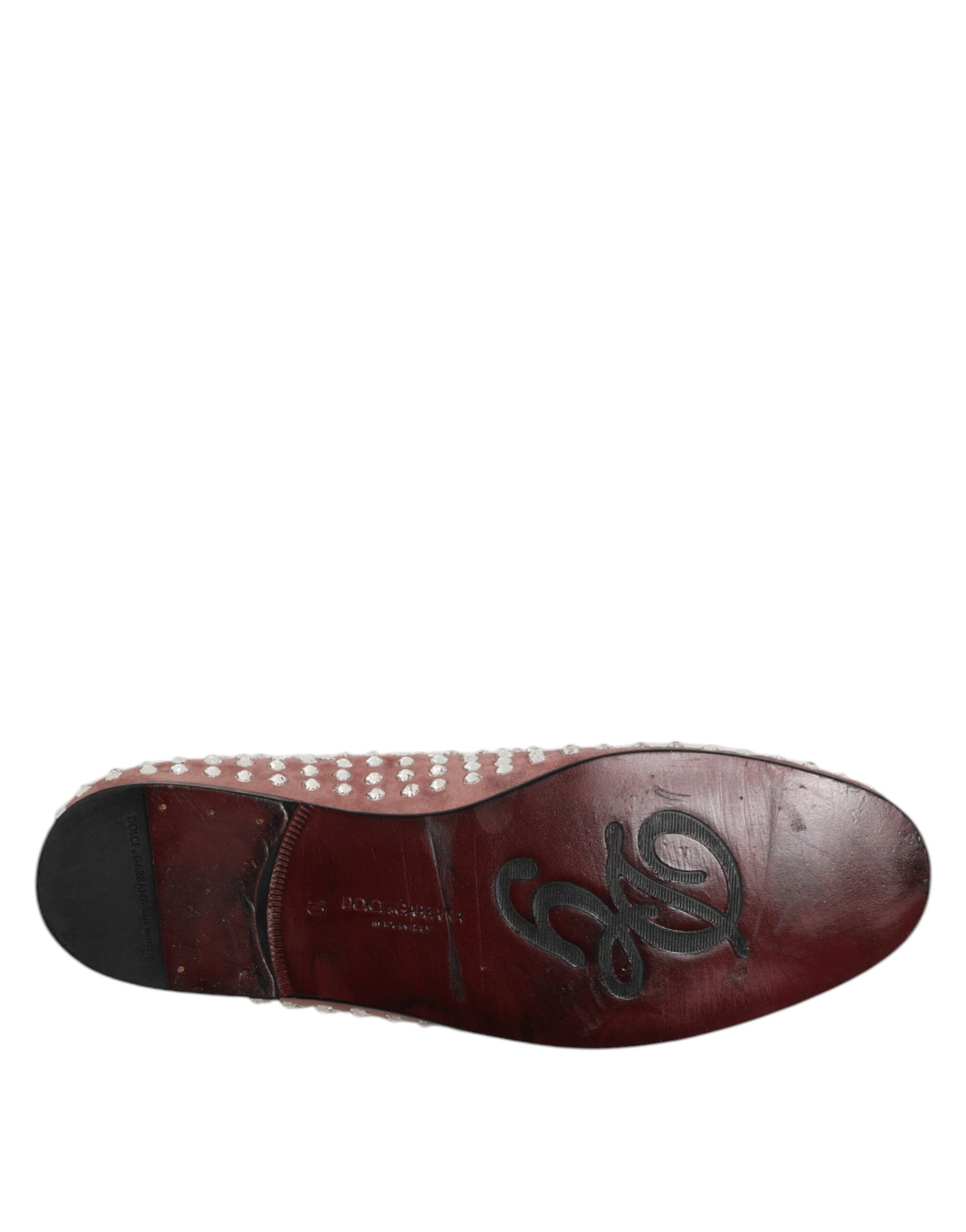 A single red loafer shoe with a suede texture and crystal embellishments