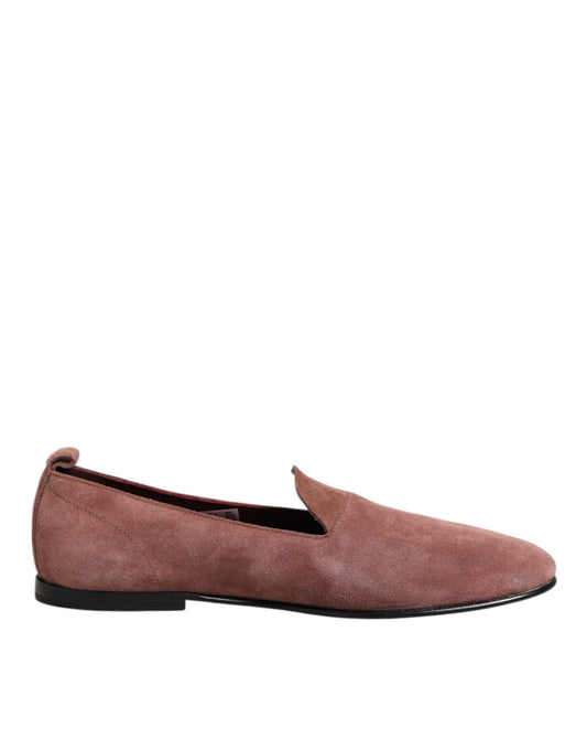 A pair of men's formal dress shoes in pink suede with black soles