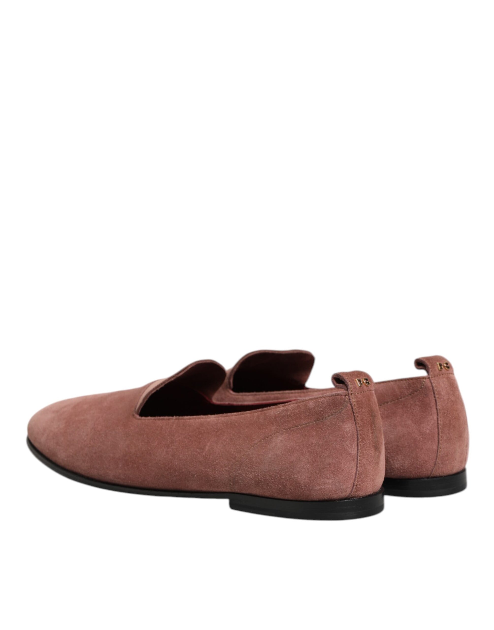 A pair of men's formal loafers in pink suede with black soles