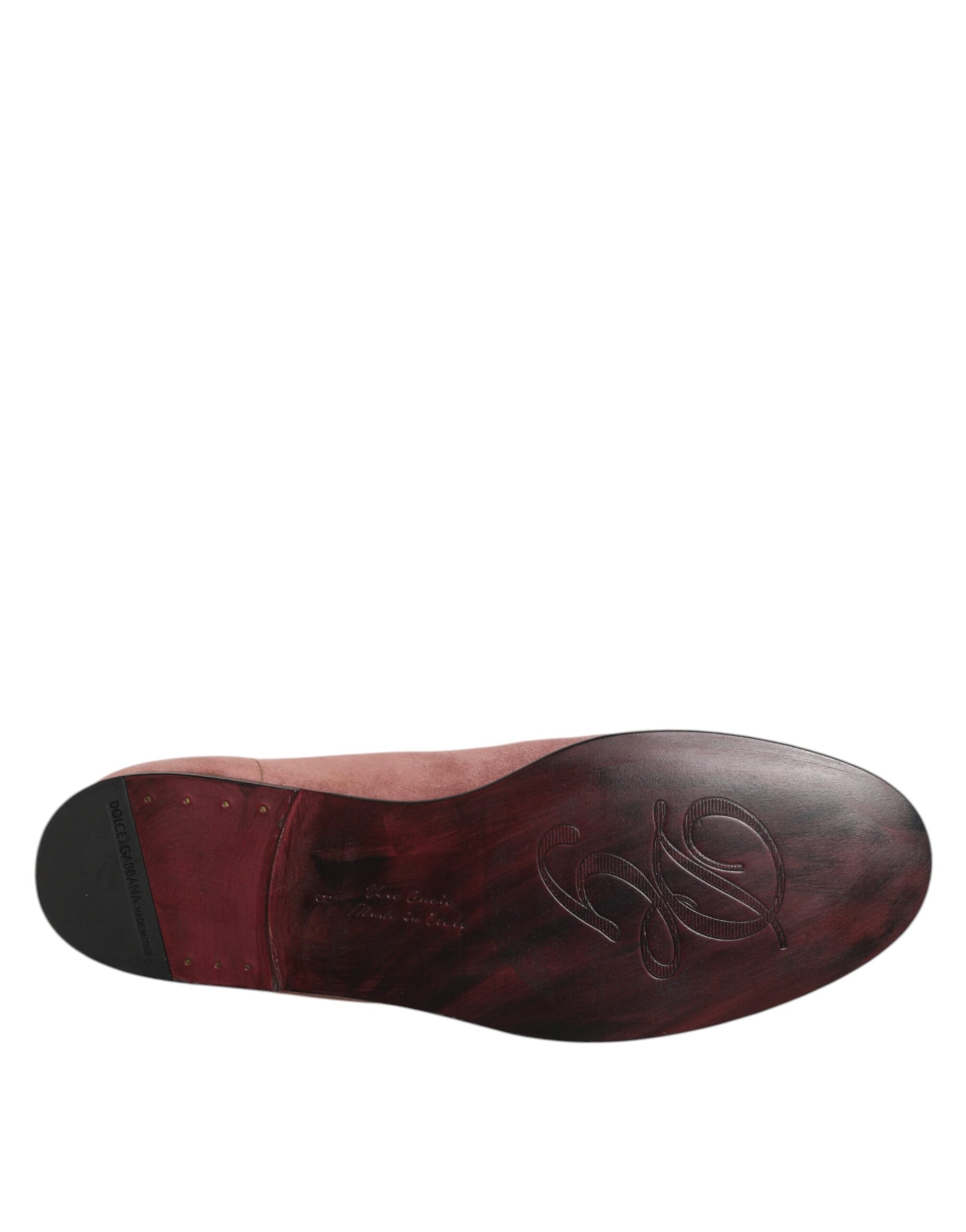A pair of red suede loafers with a black sole, featuring the Dolce & Gabbana logo