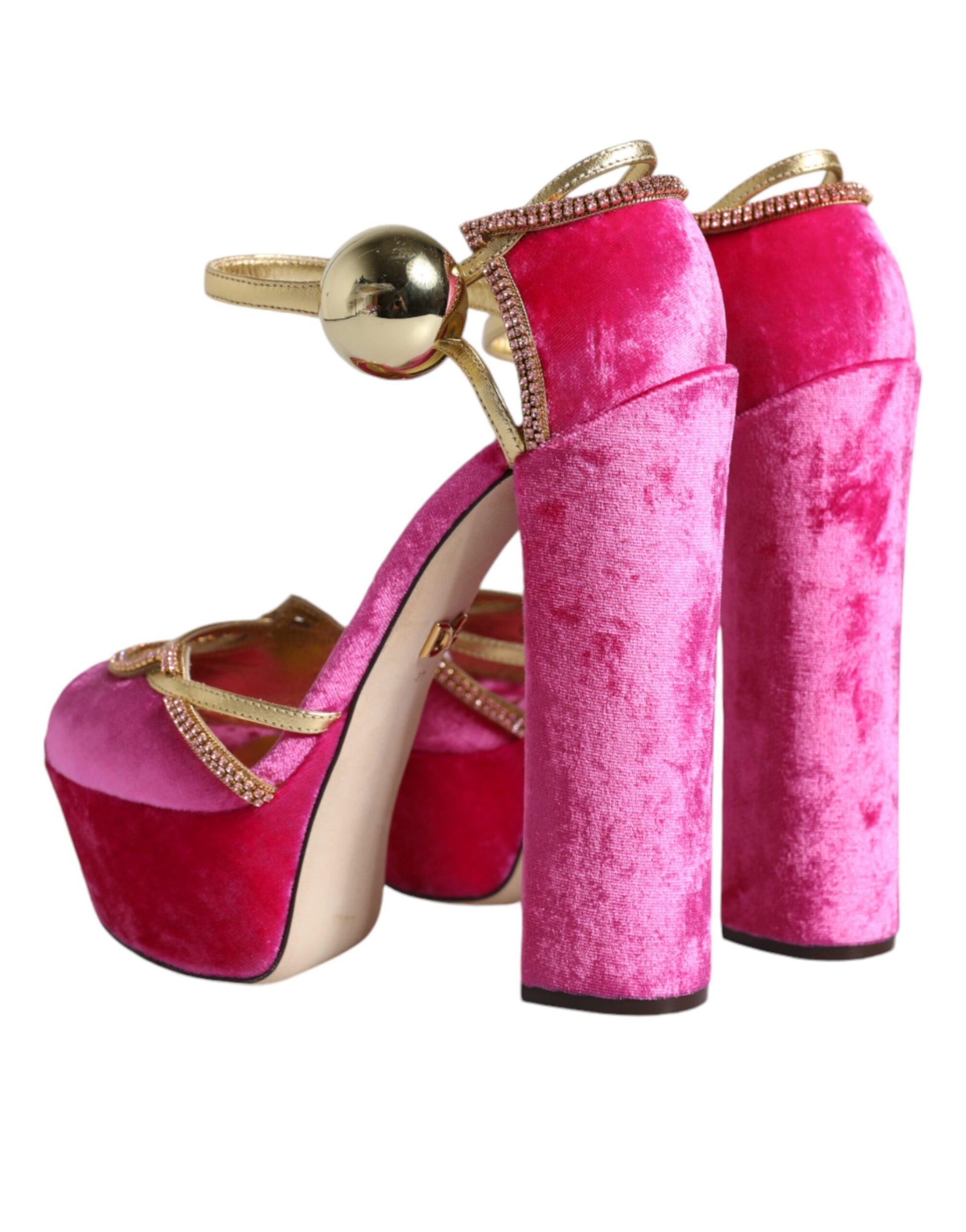 Pair of high heel shoes with pink furry material and gold accents