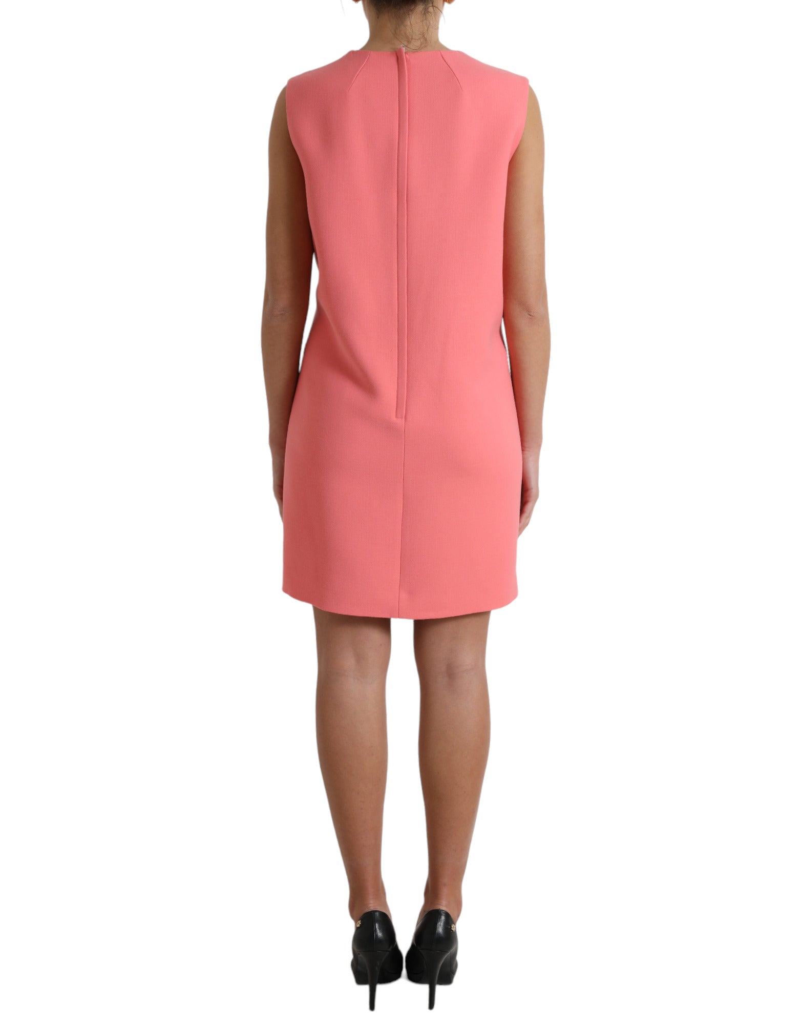 A sleeveless pink dress with a high neckline and a fitted silhouette