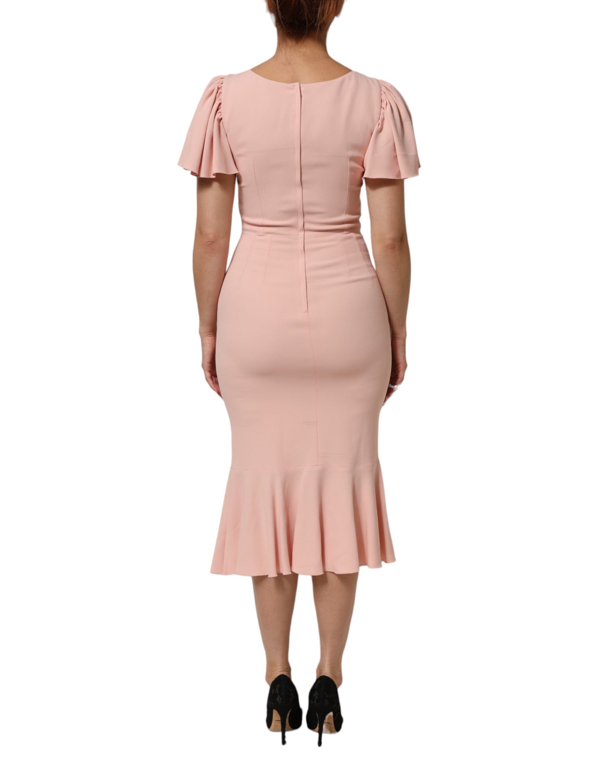 A pink midi dress with ruffled sleeves and a flared skirt