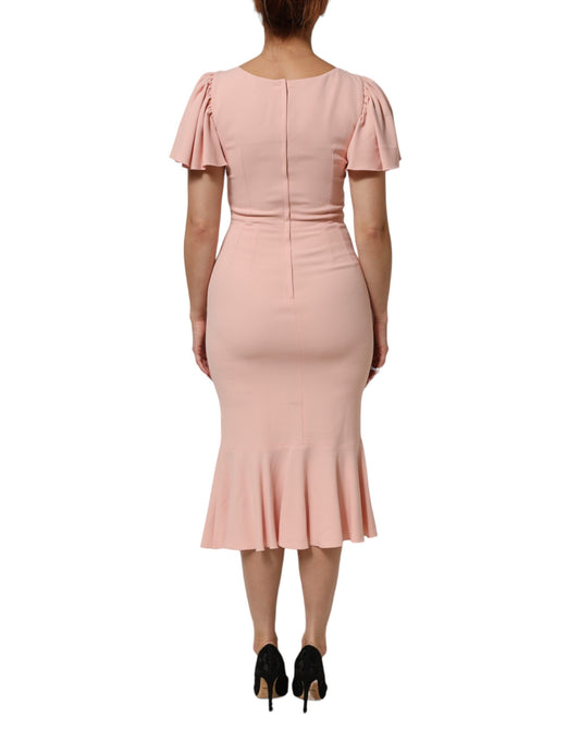 A pink midi dress with ruffled sleeves and a flared skirt