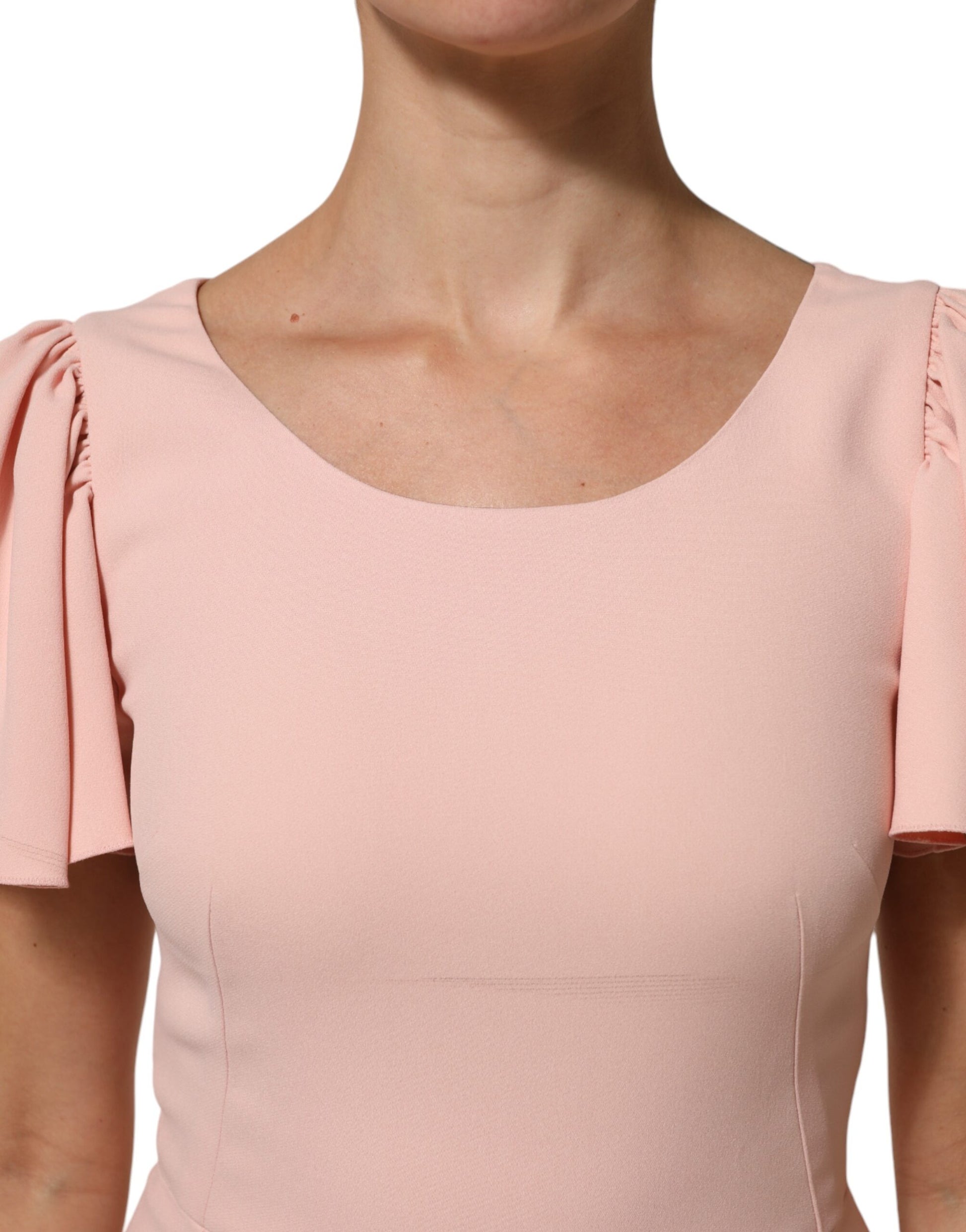 A pink midi dress with ruffled sleeves and a fit-and-flare silhouette