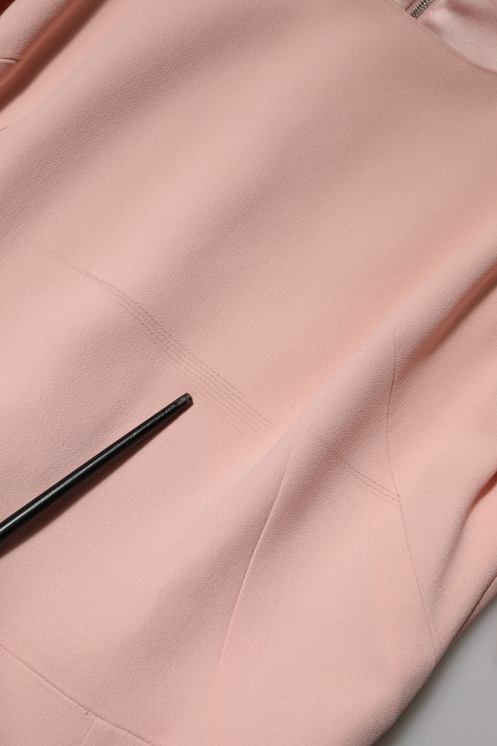 A pink viscose midi dress with a fit and flare silhouette