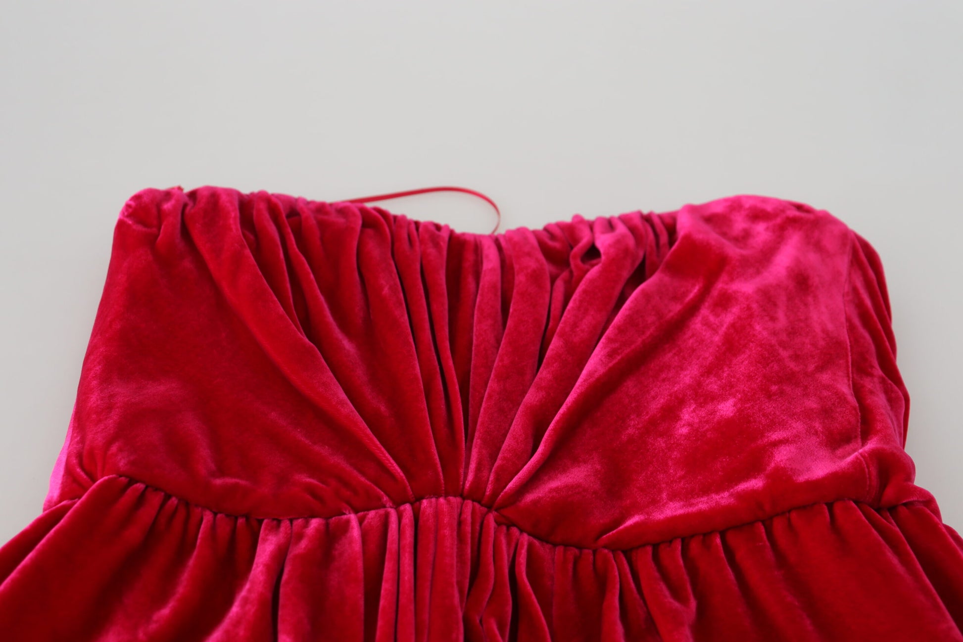 Red velvet strapless dress with ruffled hem and bodice