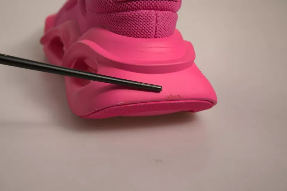 Pink shoe on white surface