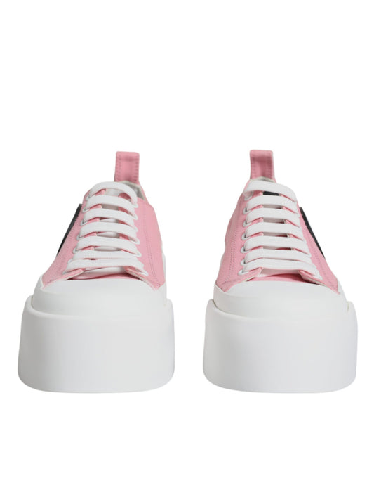 Pair of pink and white canvas shoes with logo on side