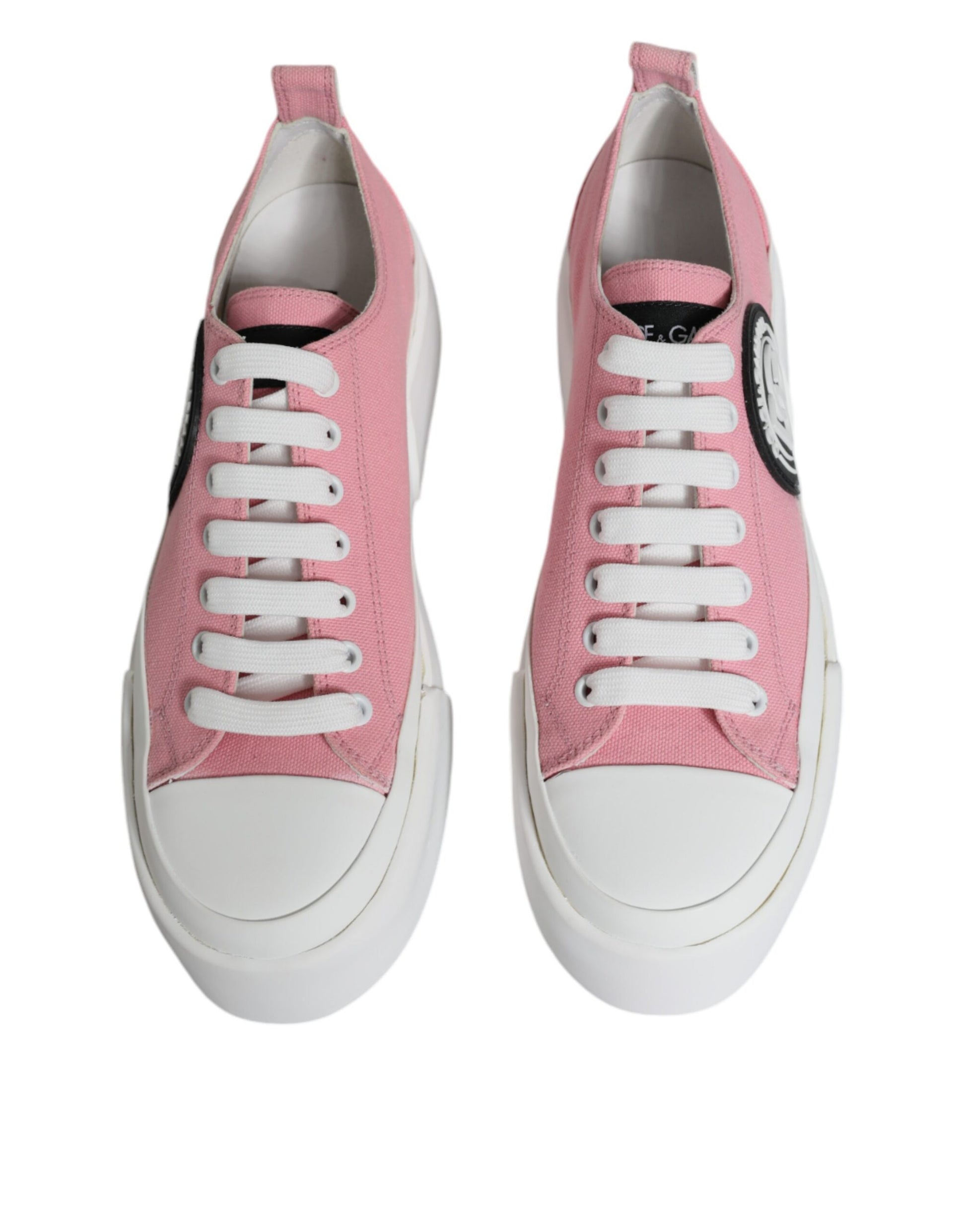 Pair of pink and white canvas sneakers with logo on side