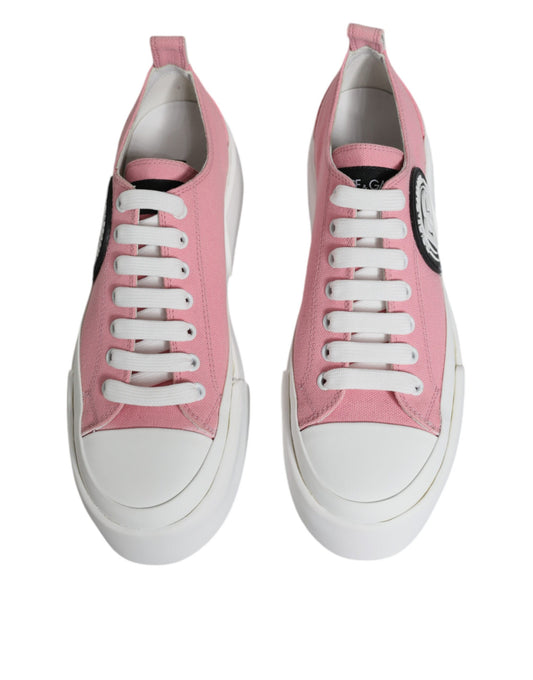 Pair of pink and white canvas sneakers with logo on side