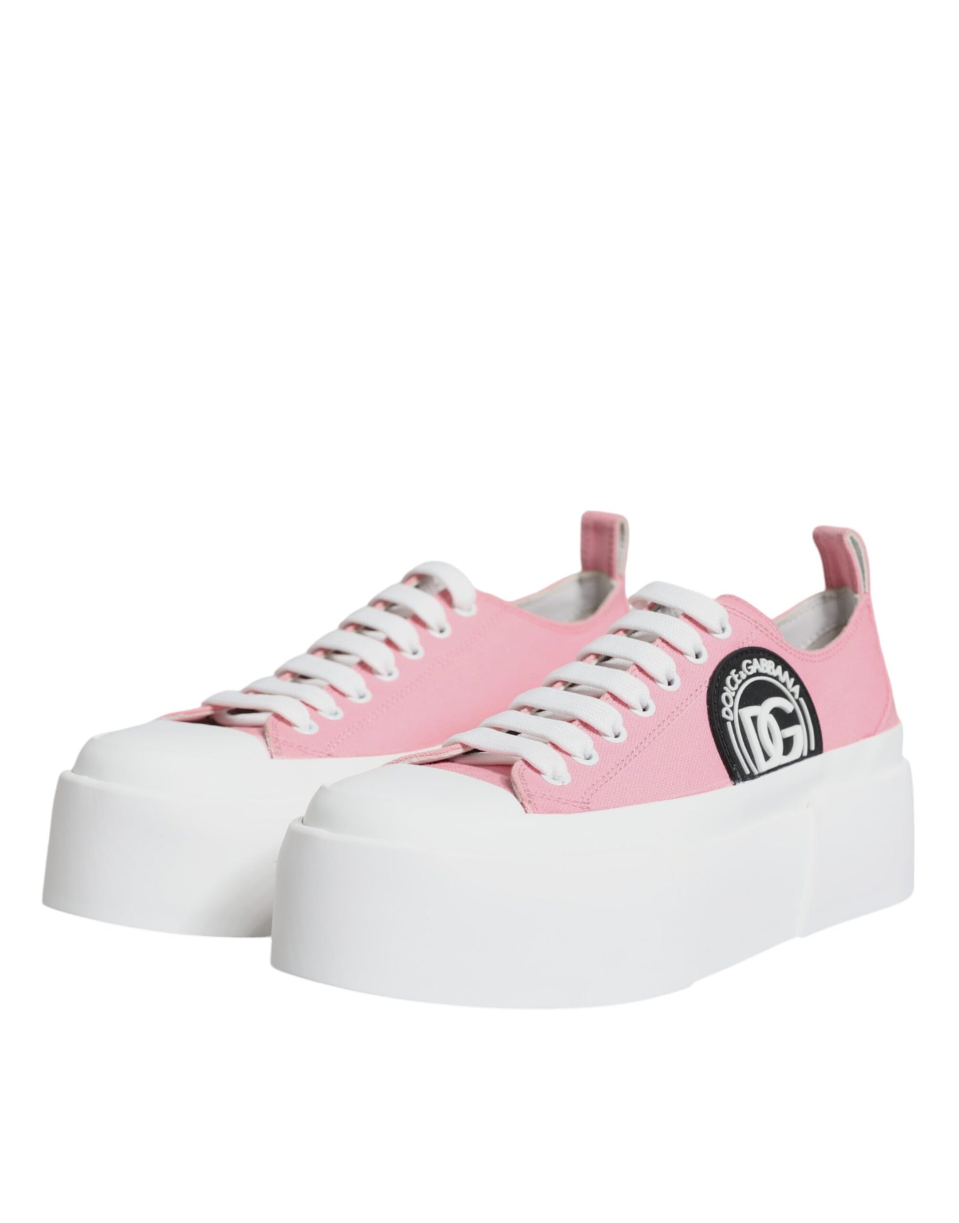 Pink and white canvas shoes with logo on side