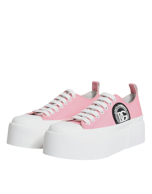Pink and white canvas shoes with logo on side