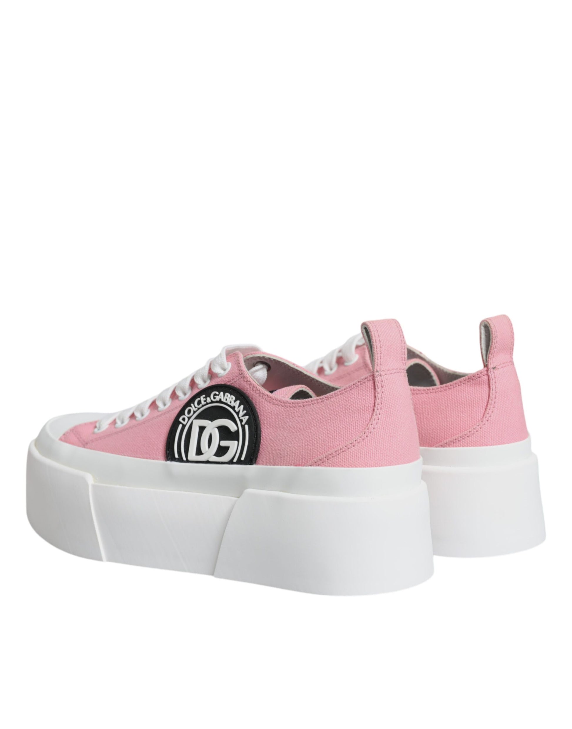 Pair of pink and white canvas sneakers with logo on side