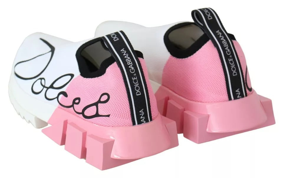 Pair of pink children's sneakers with white laces and black branding